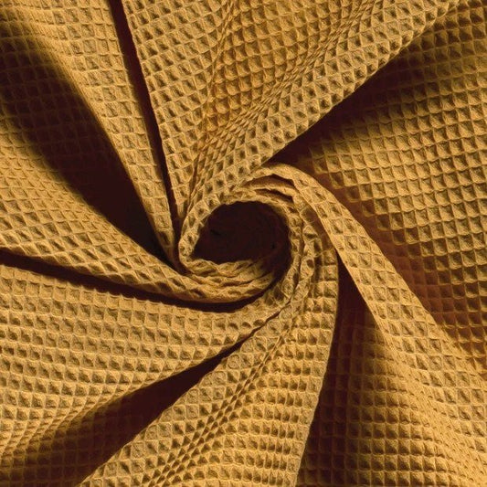 https://www.littlerhodysewingco.com/cdn/shop/products/autumn-gold-turkish-waffle-100-cotton-by-the-12-yard-907435.jpg?v=1676588113&width=533